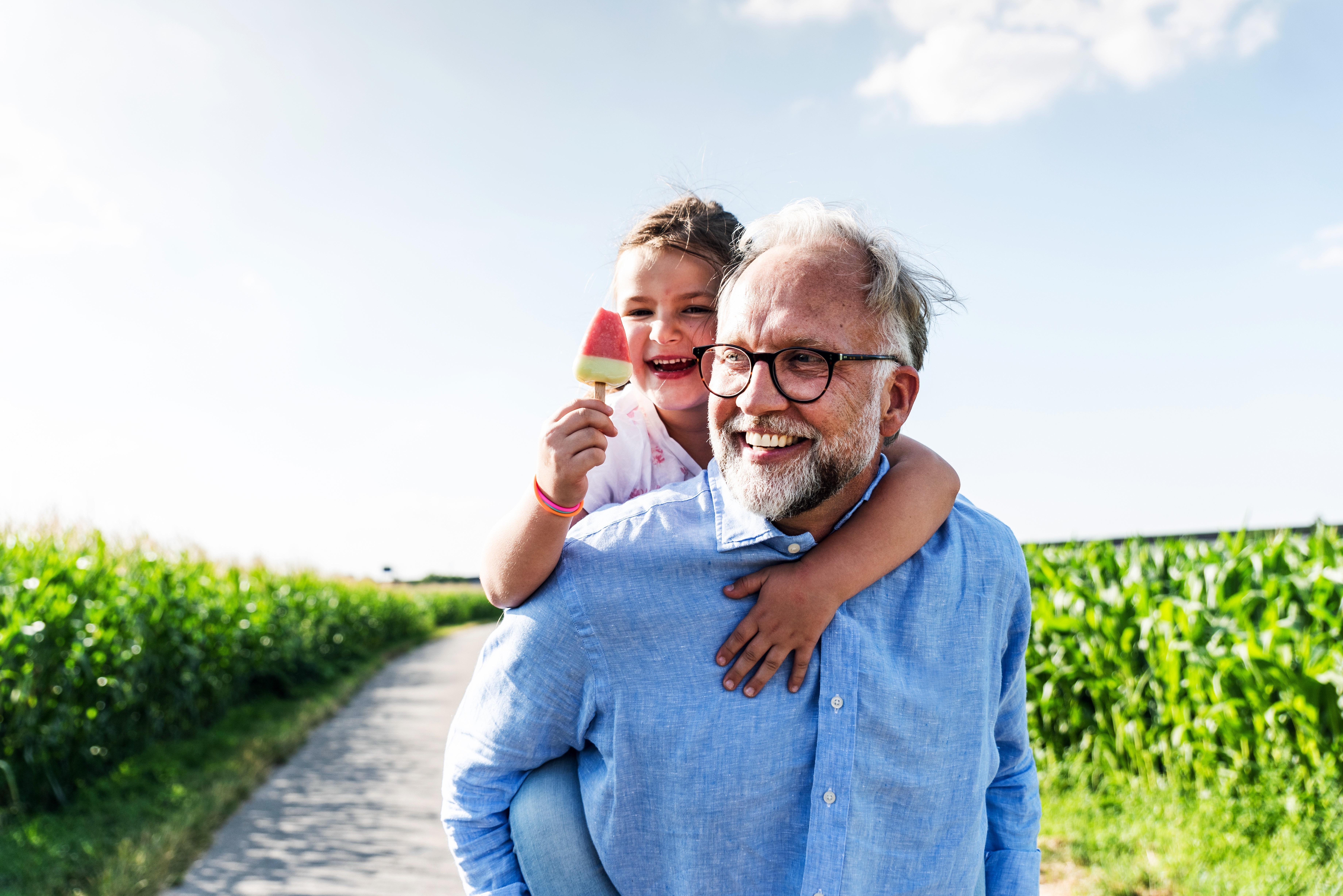 Sustainability Report Cover Image Grandfather Holding Grandchild